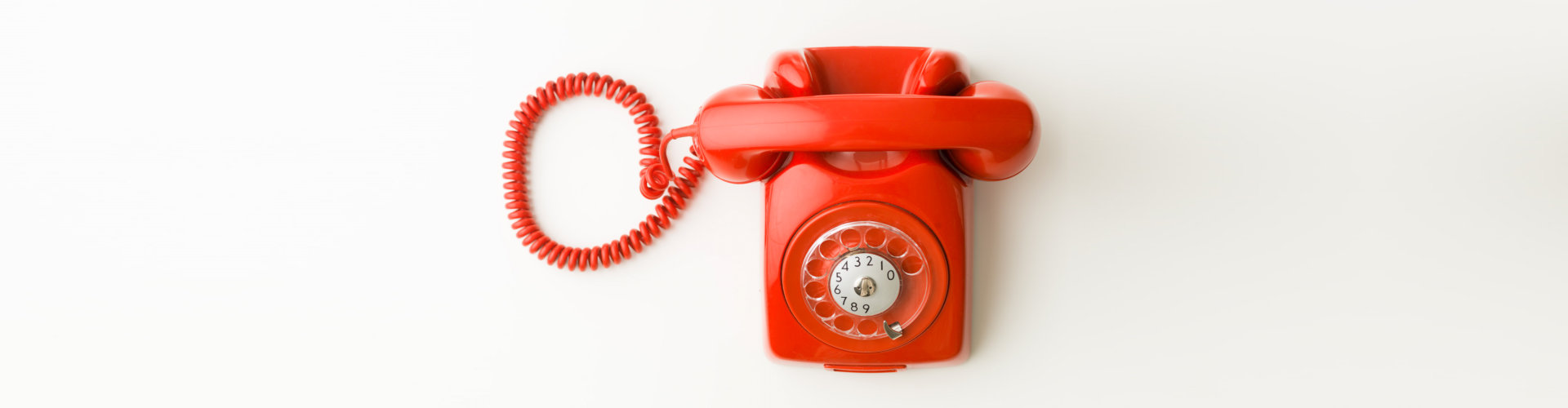 Top view of red vintage phone on white background